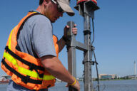 Hydrologic technician with the U.S. Geological Survey secures an ADCP to monitor hydrology conditions